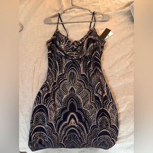 a stunning navy blue dress with golden accents and droop neckline.